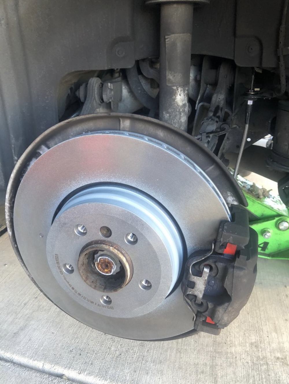 A new brake rotor and caliper installed on a car